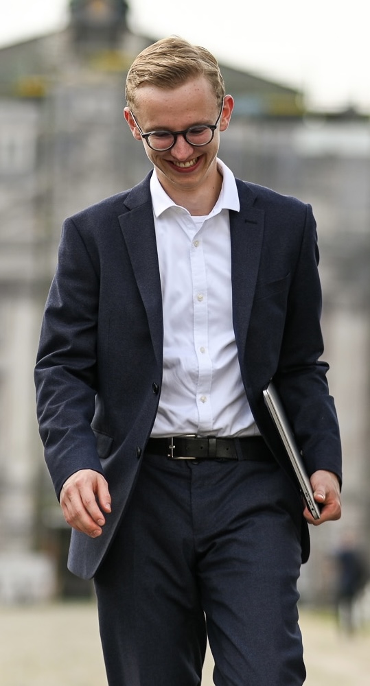 David Blomeyer walking with a laptop between meetings